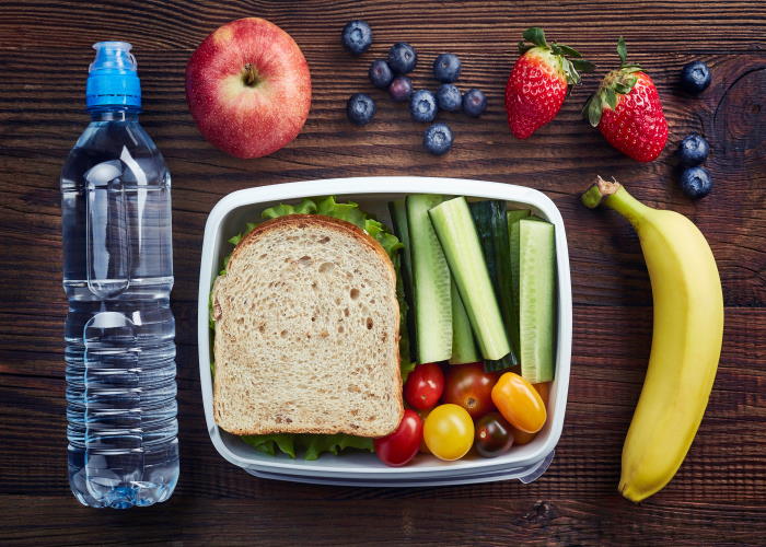 Dietary intake - healthy school lunchbox with a sandwich and fruit.