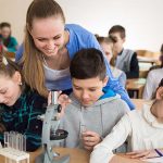 Students,Using,Science,Beakers,And,A,Microscope,At,The,Elementary