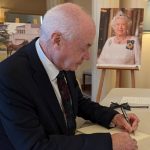 CEO Rohan Greenland signs the condolence book